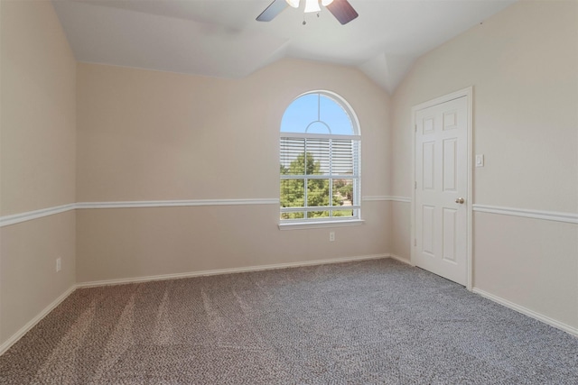unfurnished room with carpet floors, baseboards, a ceiling fan, and vaulted ceiling