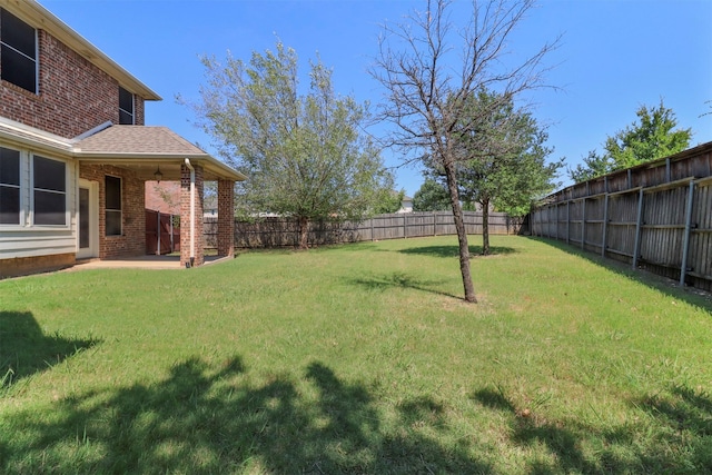 view of yard with a fenced backyard and a patio