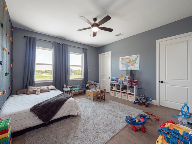 1515 Malone Dr, Royse City, TX 75189 - bedroom with visible vents, baseboards, a ceiling fan, and wood finished floors