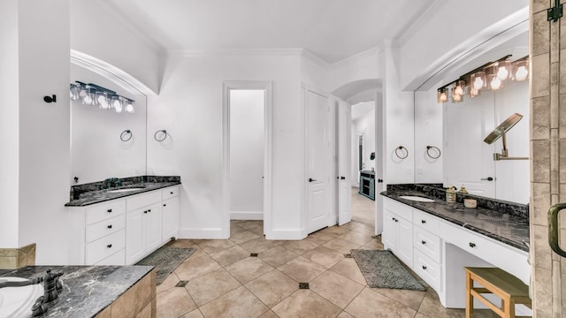 full bath with tile patterned floors, two vanities, a sink, and ornamental molding