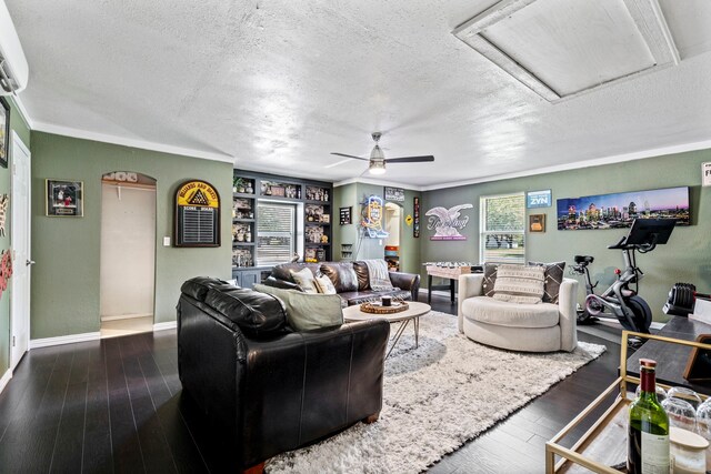 living area featuring wood-type flooring, attic access, and a textured ceiling