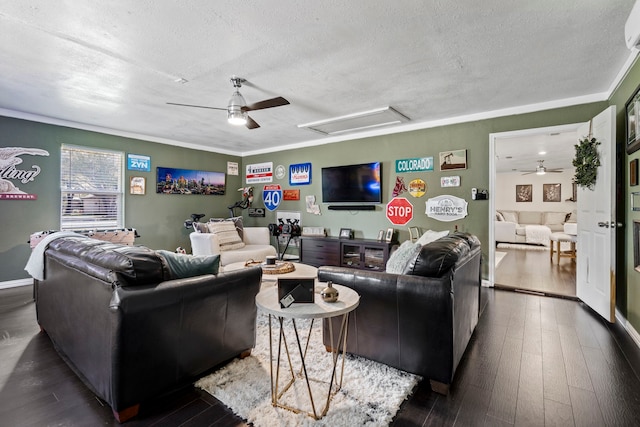 living room with a ceiling fan, attic access, wood finished floors, and a textured ceiling