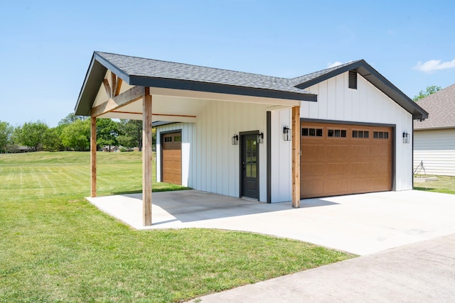 view of front of house featuring board and batten siding, a shingled roof, a front yard, and a garage