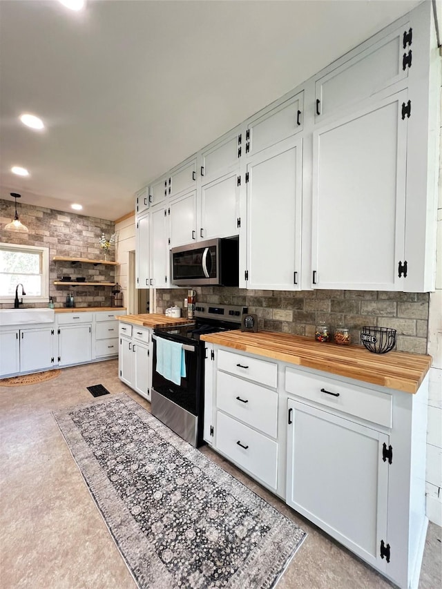 143 Lisa Layne St, Gun Barrel City, TX 75156 - kitchen featuring stainless steel appliances, butcher block countertops, a sink, backsplash, and white cabinetry
