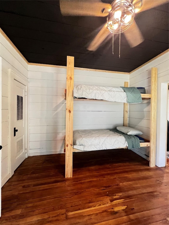 143 Lisa Layne St, Gun Barrel City, TX 75156 - unfurnished bedroom with wood-type flooring, wood walls, and a ceiling fan