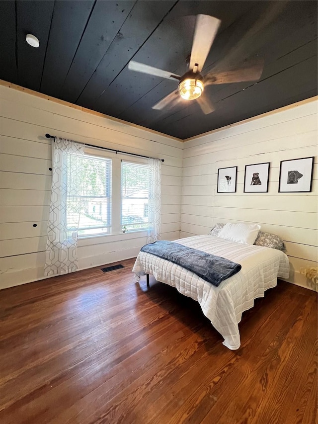 143 Lisa Layne St, Gun Barrel City, TX 75156 - bedroom with wood finished floors, wood walls, wooden ceiling, and ceiling fan