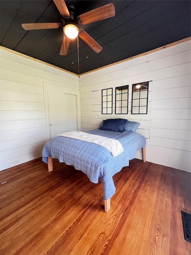 143 Lisa Layne St, Gun Barrel City, TX 75156 - bedroom with wood finished floors, wooden walls, and ceiling fan