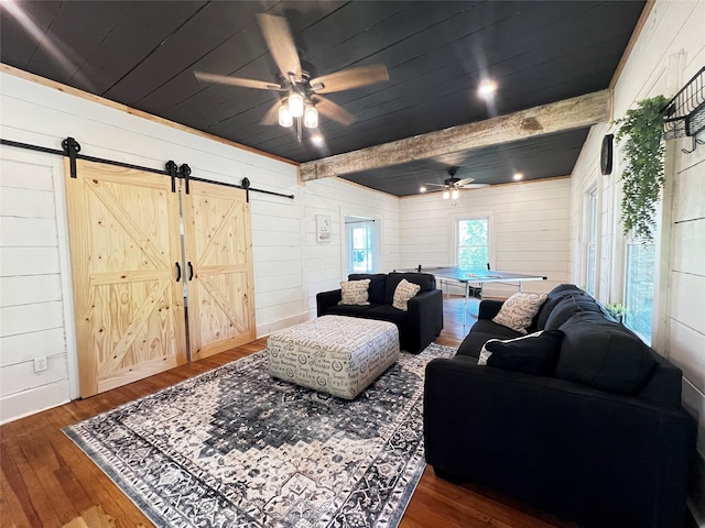 143 Lisa Layne St, Gun Barrel City, TX 75156 - living room with a barn door, a ceiling fan, wood finished floors, and wood walls