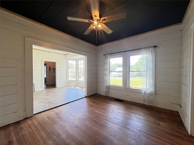 143 Lisa Layne St, Gun Barrel City, TX 75156 - empty room featuring wood finished floors, wood walls, and ceiling fan