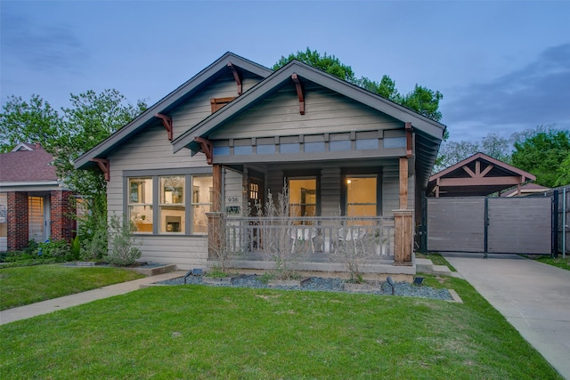 view of front of property featuring covered porch and a gate