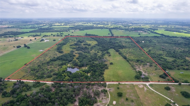birds eye view of property featuring a rural view