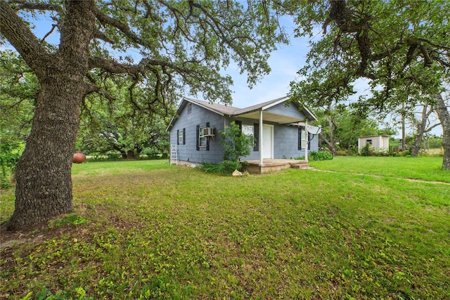 view of side of home featuring cooling unit and a lawn