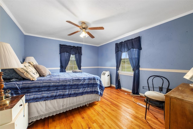 bedroom featuring a ceiling fan, light wood finished floors, baseboards, and multiple windows