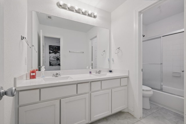 bathroom featuring double vanity, visible vents, toilet, and a sink