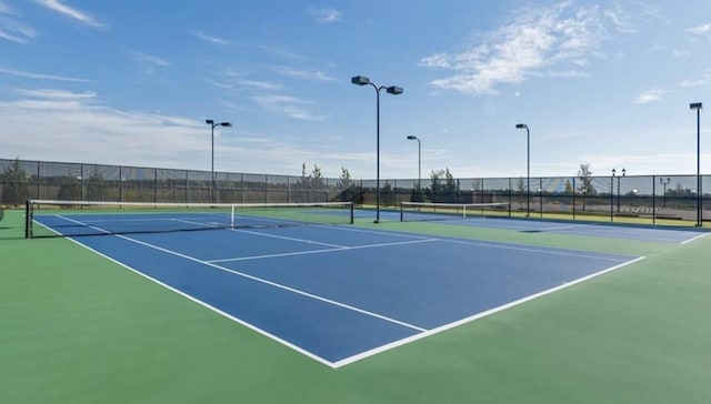 view of tennis court with fence