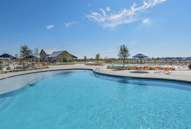 community pool with a patio area