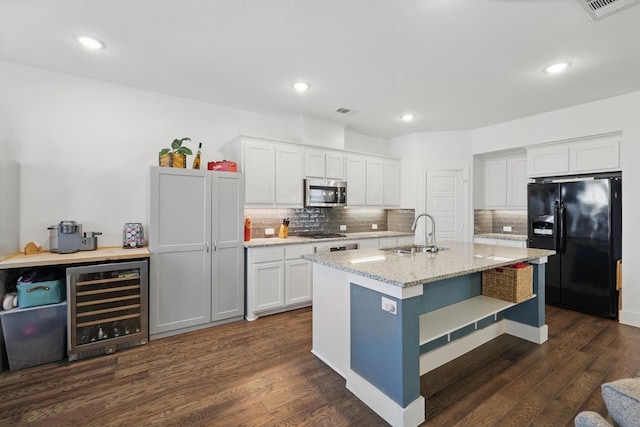 kitchen featuring a sink, decorative backsplash, appliances with stainless steel finishes, dark wood-type flooring, and wine cooler