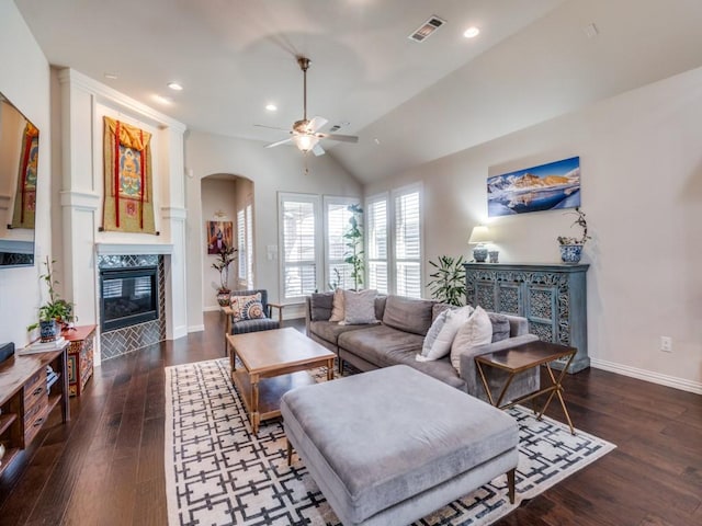 915 Enchanted Wood Dr, Arlington, TX 76005 - living area featuring wood finished floors, a fireplace, visible vents, ceiling fan, and arched walkways