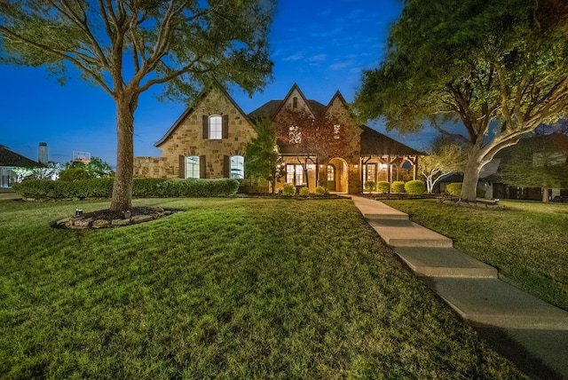 tudor house featuring a front yard