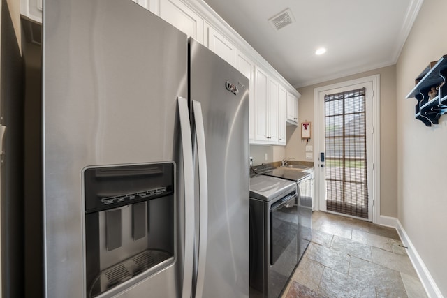 clothes washing area with recessed lighting, stone tile floors, visible vents, ornamental molding, and baseboards