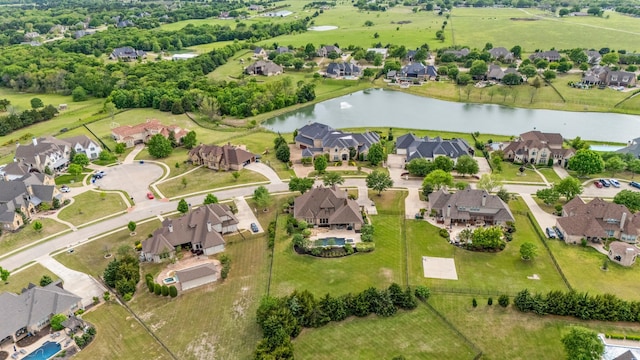 birds eye view of property with a residential view and a water view