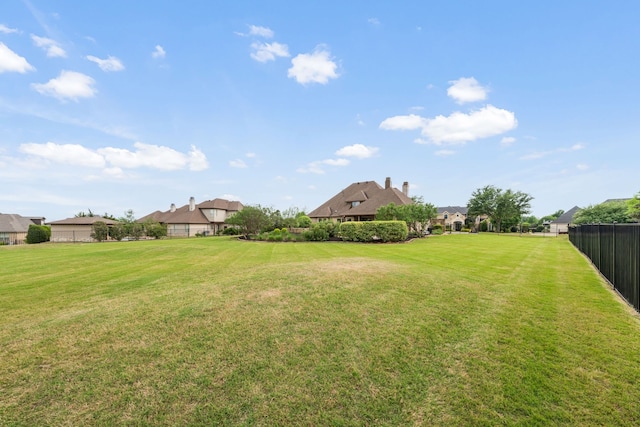 view of yard with fence and a residential view