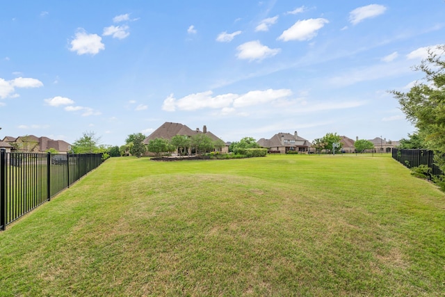 view of yard featuring fence and a residential view