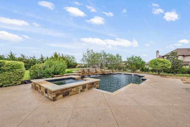 view of swimming pool featuring a pool with connected hot tub and a patio