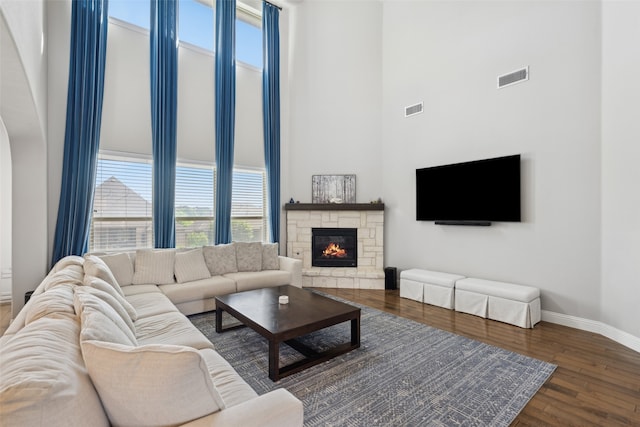 9724 Croswell St, Fort Worth, TX 76244 - living area featuring a towering ceiling, baseboards, wood finished floors, and a stone fireplace