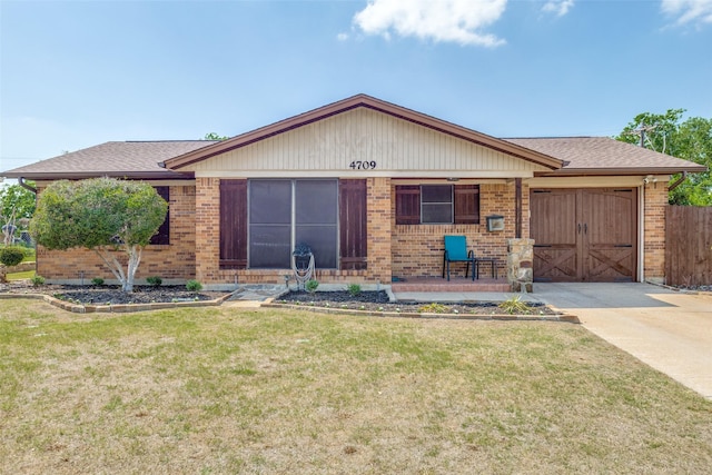 ranch-style home with driveway, a front lawn, brick siding, and a garage