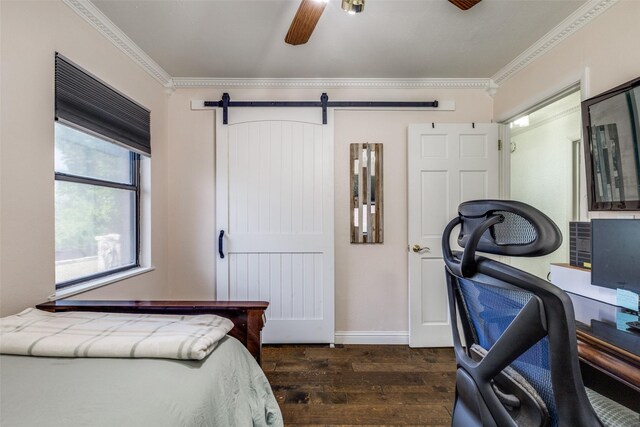 bedroom featuring crown molding, baseboards, a barn door, and dark wood-style flooring