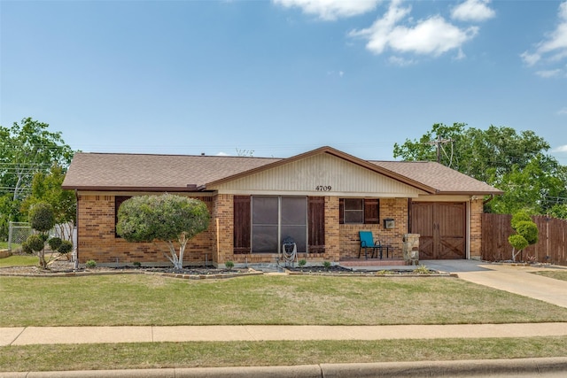 ranch-style house with a garage, driveway, fence, a front yard, and brick siding