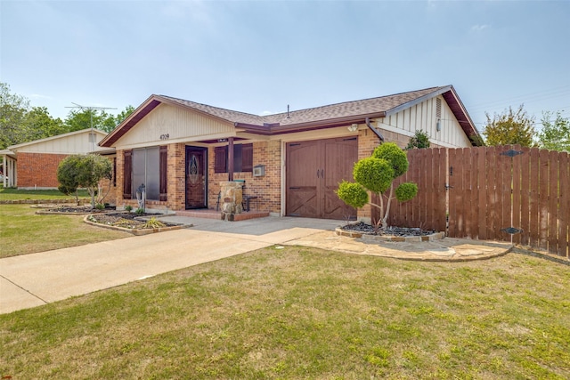 ranch-style house with fence, a front lawn, driveway, brick siding, and a garage