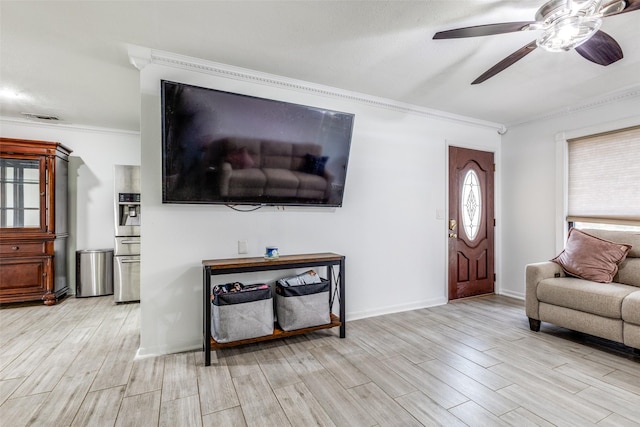 living area with ceiling fan, visible vents, light wood finished floors, and ornamental molding