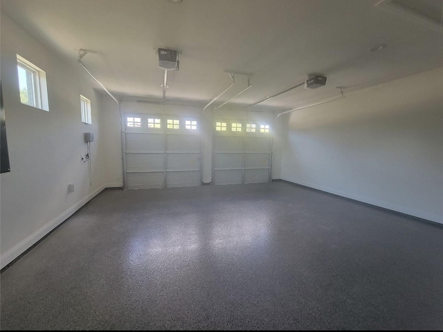 garage with baseboards and a garage door opener