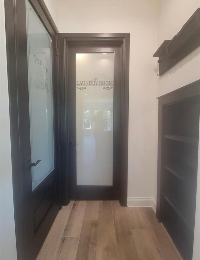 entryway featuring baseboards and light wood-style floors
