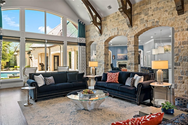 6615 Bluffview Dr, Frisco, TX 75034 - living room with high vaulted ceiling, arched walkways, and wood finished floors