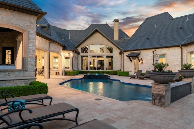 6615 Bluffview Dr, Frisco, TX 75034 - pool at dusk with an outdoor pool and a patio area