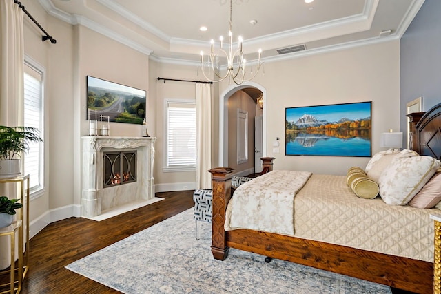 6615 Bluffview Dr, Frisco, TX 75034 - bedroom with visible vents, a raised ceiling, arched walkways, and wood finished floors