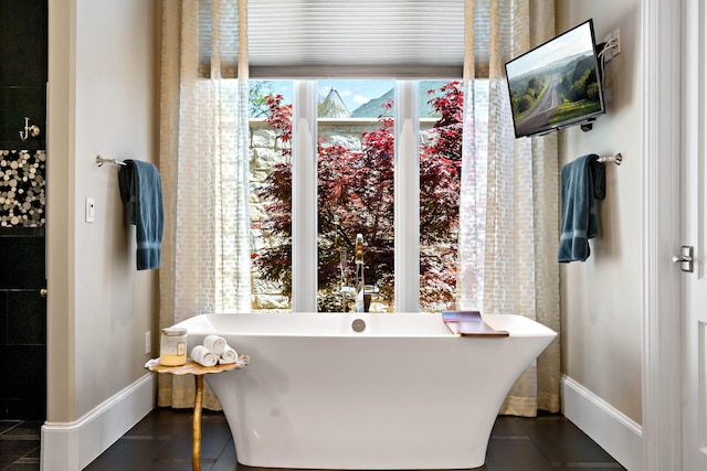 6615 Bluffview Dr, Frisco, TX 75034 - full bathroom with baseboards, a freestanding tub, and tile patterned floors