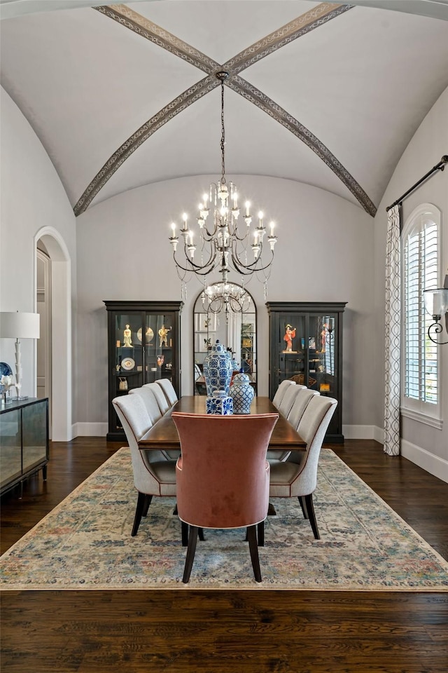 6615 Bluffview Dr, Frisco, TX 75034 - dining space with baseboards, arched walkways, a notable chandelier, dark wood finished floors, and vaulted ceiling