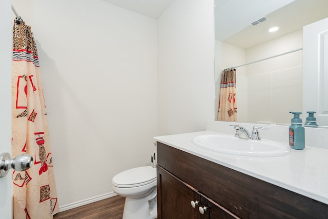 full bathroom featuring visible vents, baseboards, toilet, vanity, and wood finished floors