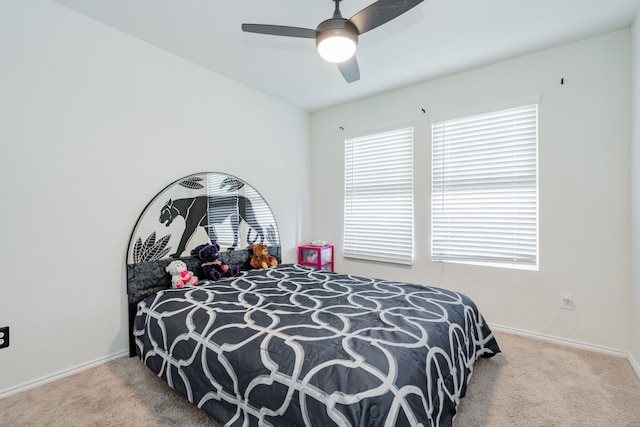 bedroom featuring ceiling fan, baseboards, and carpet