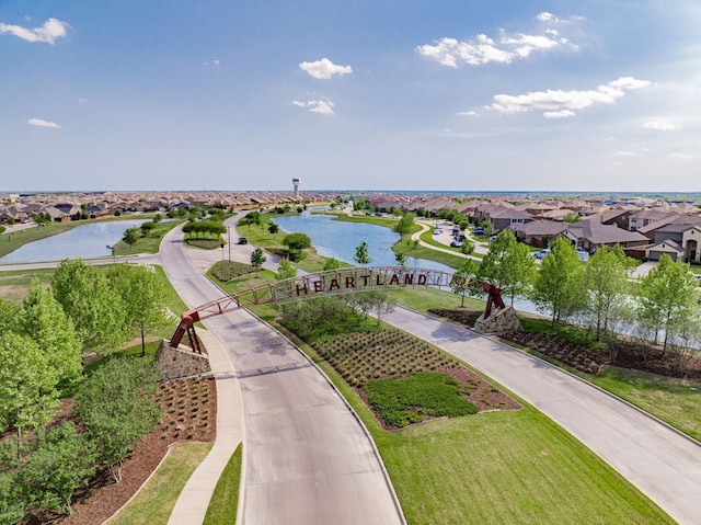 drone / aerial view with a water view and a residential view