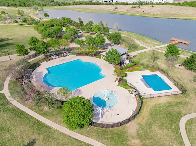 community pool with a water view, a patio area, a fenced backyard, and a yard
