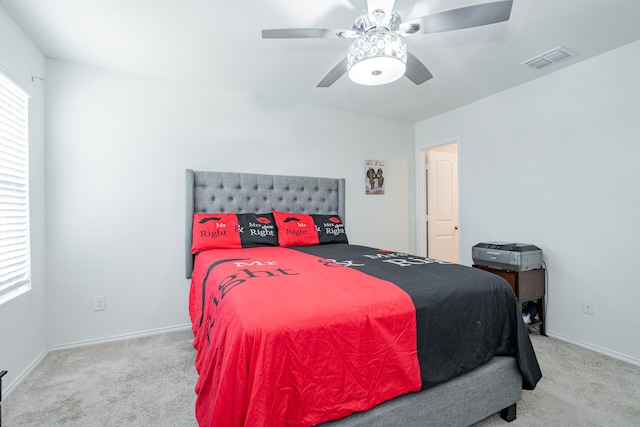 carpeted bedroom featuring visible vents, ceiling fan, and baseboards