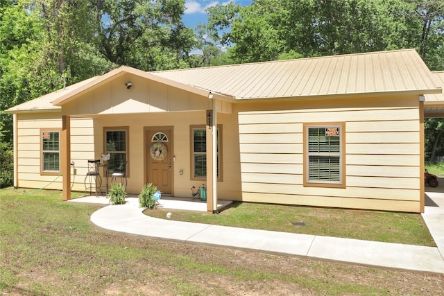 411 Johnson St, Longview, TX 75602 - view of front of house with metal roof and a front yard