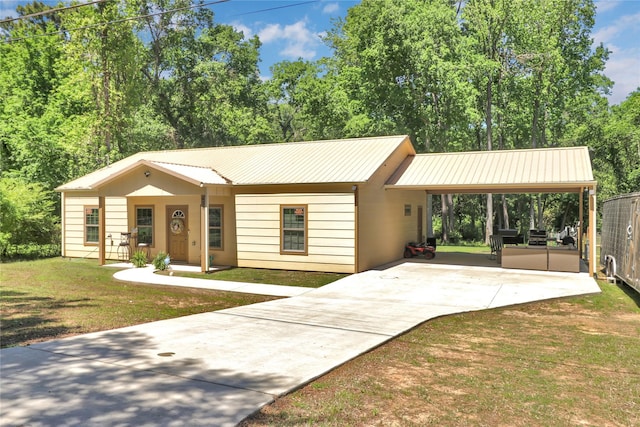 411 Johnson St, Longview, TX 75602 - ranch-style house featuring concrete driveway, a carport, a front lawn, and metal roof
