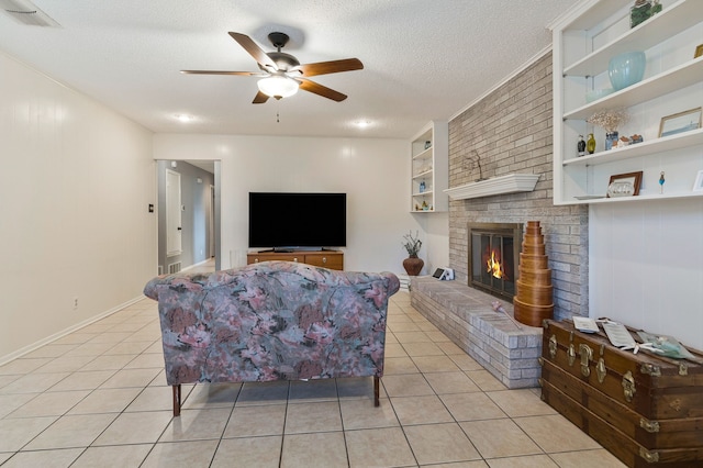 living area featuring light tile patterned floors, ceiling fan, visible vents, and built in shelves