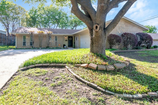 ranch-style home featuring concrete driveway, brick siding, and an attached garage
